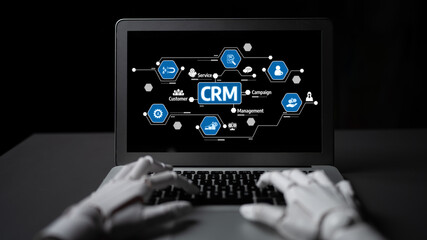 Futuristic image showcasing robotic hands interacting with a laptop, featuring a dynamic Customer Relationship Management interface and various network connections. Tessel