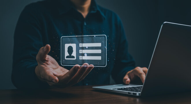 Digital identity concept, a person interacting with an ID card and laptop.