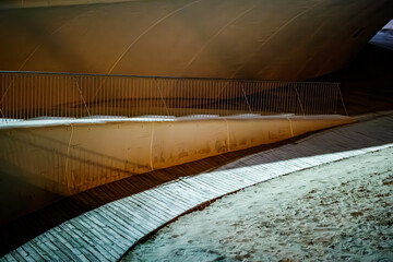 Warm Glow Beneath the Promenade's Curved Underbelly