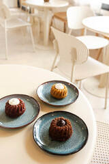 Sweet mini cakes with frosting on cafe table