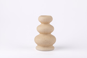 Beige stone candle holder with rounded shapes on white background, modern and minimalist composition with copy space. Concept of natural home decor and soft aesthetics