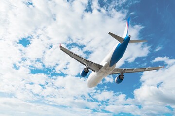 Bright passenger airplane plane flying in sky