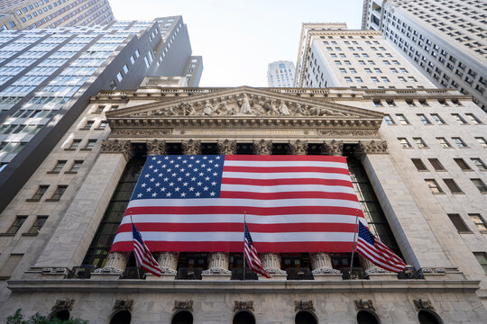 New York, NY, USA - July 4, 2022: Low angle view of the main facade of the New York Stock Exchange (NYSE) Building in the Financial District of Lower Manhattan in New York City on the 4th of July.