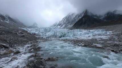 Obraz premium Melting Glacier Carving Through Icy Valley with Rapid River Flowing Beneath Overcast Sky and Majestic Mountain Peaks