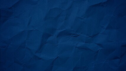 Crumpled dark blue paper background with wavy surface texture. Abstract blue paper texture for modern design. Wrinkled paper background with copy space for text.
