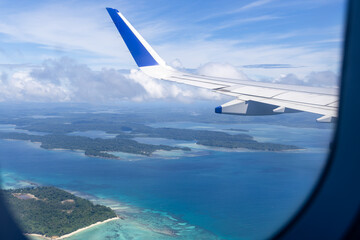 Obraz premium airplane wing view above clouds during daylight flight