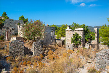 Fototapeta premium Fethiye Kayaköy stone houses and ruins. Mugla, Turkey. Kayakoy ghost village. Turkey's abandoned houses. The Ghost Town of Kayakoy. Abandoned religious ghost city.