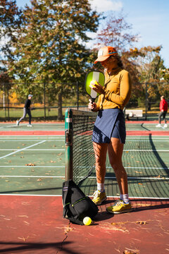 Woman preparing to play pickleball in autumn