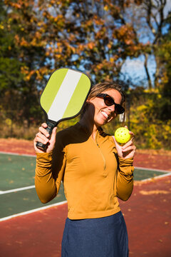 Woman playing pickleball in autumn