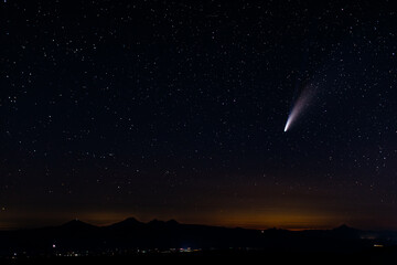Comet shooting through star lit sky