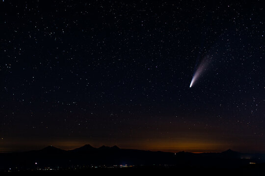 Comet shooting through star lit sky