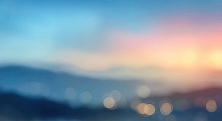 Blurred scenic mountains at dawn with warm, soft sunrise hues and bokeh lights