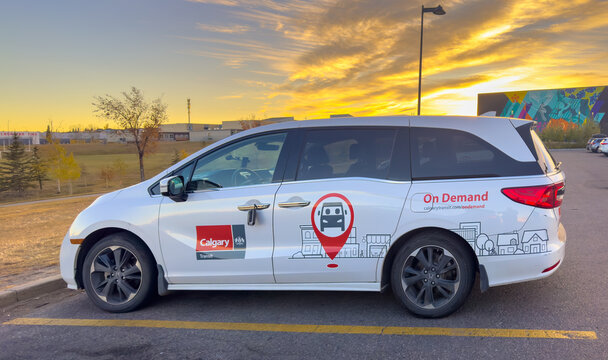 Calgary, Alberta, Canada. Oct 23, 2025. Calgary Transit's "On Demand" minivan service vehicle parked at sunset, highlighting urban transportation solutions and public transit innovation.