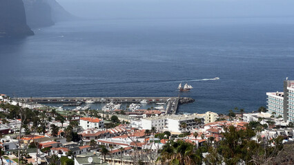 A Stunning Aerial View Showing a Coastal Town with a Busy Port and the Vast Ocean Beyond