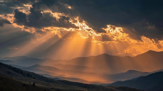 Dramatic sunbeams pierce stormy clouds over majestic layered mountain silhouettes at sunset - Powered by Adobe