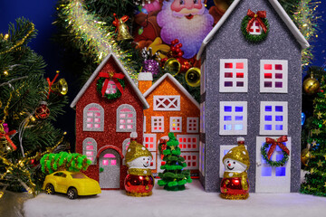 In the Christmas town, colorful decorated houses are surrounded by Christmas trees and snowmen