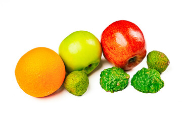 A colorful mix of apples, oranges, and kaffir limes arranged on a clean white background for fresh food and diet concept photography.