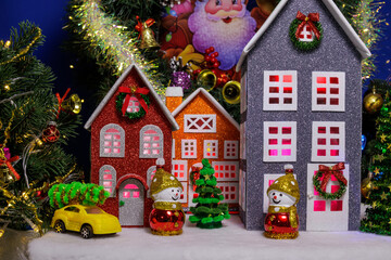 In the Christmas town, colorful large houses are surrounded by Christmas trees and snowmen