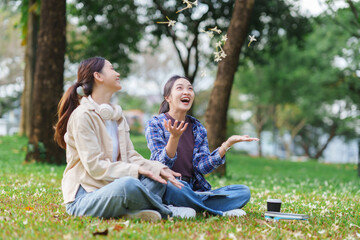 Young women friends enjoying freedom in park