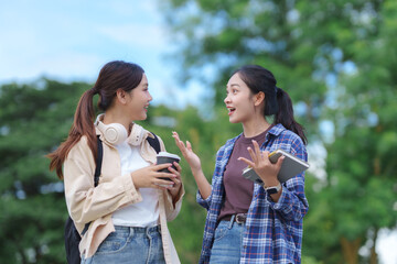 Two young students chatting outdoors on campus
