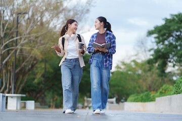Students walking and talking on campus path