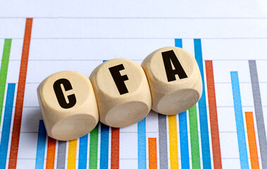 CFA word on wooden round blocks with colorful bar chart background