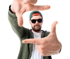Naklejka premium Handsome male hip-hop dancer making frame with his hands on white background