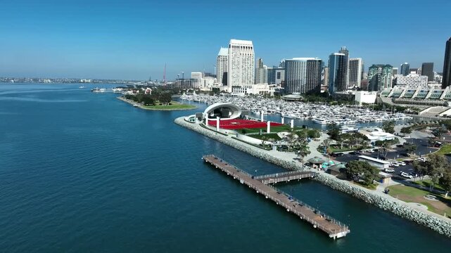 Aerial pullback of Rady Shell, marina and the skyline of downtown San Diego during clear day over the Pacific Ocean