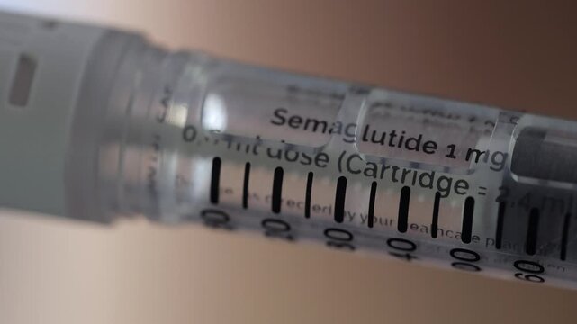 Close-up medication injection pen turns to reveal 1mg semaglutide