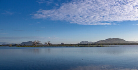 clouds over lake with mountains landscape , Sri Lanka, Thissa wewa
