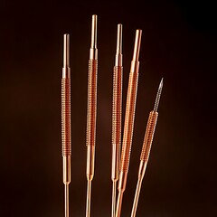 Detailed close-up of slender, metallic tools against a gradient backdrop