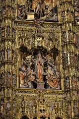 Seville, Spain 03.24.2019: The unique carved wooden Altar Mayor (Main Altar) in Capilla Mayor (Main Chapel) of Seville Cathedral