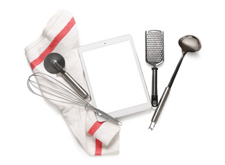 Digital recipe book with napkin and kitchen utensils on white background