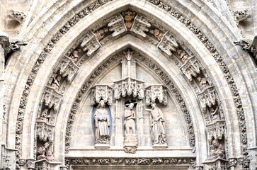 Fototapeta premium Detail of the Door of the Baptism at the world largest gothic cathedral in Seville, Spain
