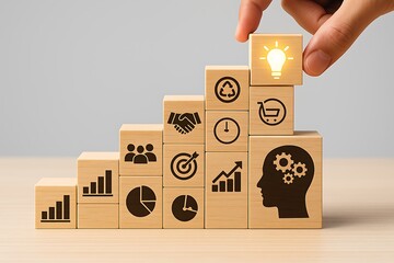 Hand stacking wooden blocks with ideas icons representing creative business success management teamwork strategy innovation and leadership development growth steps inspiration concept progress.