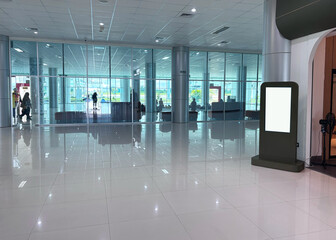 Brightly lit airport terminal features modern architecture and digital signage, creating a clean and efficient travel experience for passengers.