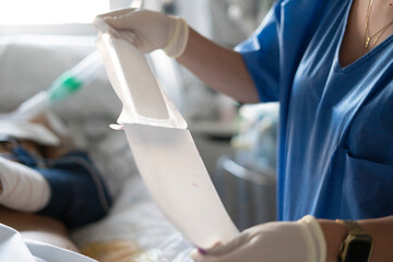 Nurse hands holding urine bag providing patient care