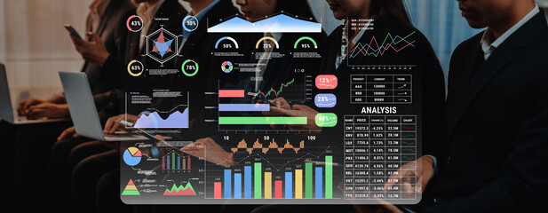 A dynamic scene of professionals engaged in a business meeting. The transparent screen displays various charts and graphs, showcasing financial data analysis and insights. Trope