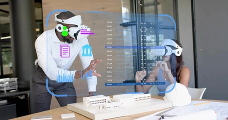 Collaborating professionals wearing VR headsets examining model in office, with holographic data
