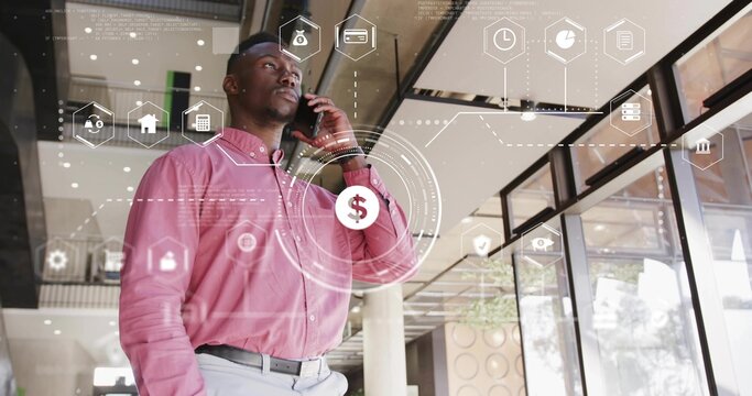 Talking businessman wearing pink shirt checking smartphone in office lobby, with finance overlays