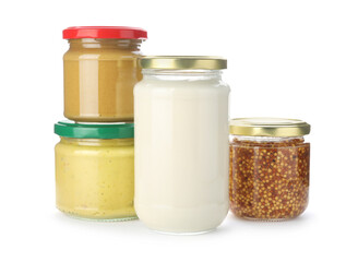 Jars with different tasty sauces isolated on white