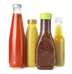 Bottles with different tasty sauces isolated on white