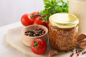Bottles of different tasty sauces and products on white wooden table, closeup