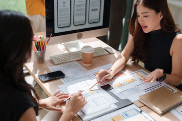 Designers collaborating on mobile application ui ux design