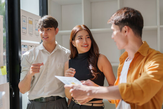 Young creative team brainstorming ui ux design - Powered by Adobe