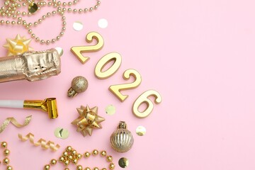 New 2026 Year. Golden numbers, shiny baubles, beads, confetti and bottle of sparkling wine on pink background, flat lay. Space for text