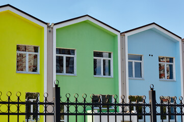Facade of kindergarten or private school colorful building. Bright building on a sunny day with a blue sky