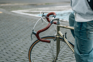 close-up of vintage bicycle handlebars with cyclist on the street