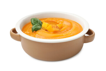Delicious pumpkin cream soup with basil isolated on white