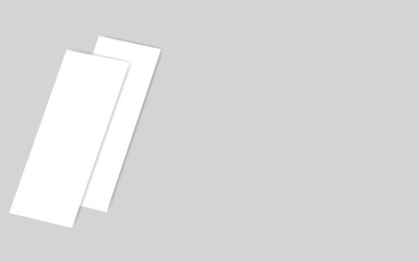 Two blank white rectangular cards or papers angled on a plain light gray background